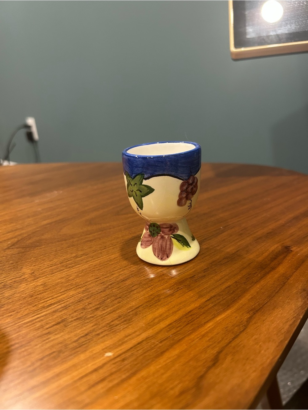 Hand-Painted Ceramic Egg Cup with Blue Rim and Floral Motif